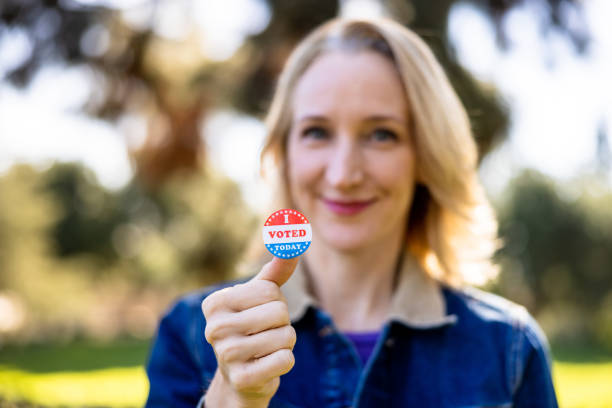 istock Blond woman with an I Voted Sticker 1458028883