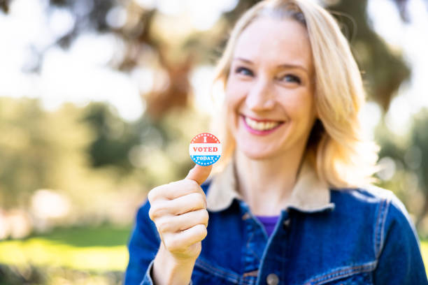 istock Blond woman with an I Voted Sticker 1458028900