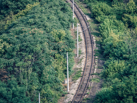 View from above with railroad tracks surrounded by forest near Veliko Tarnovo, Bulgaria.