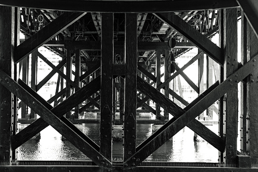 Black and white old structure under the bridge, abstract background, full frame horizontal composition