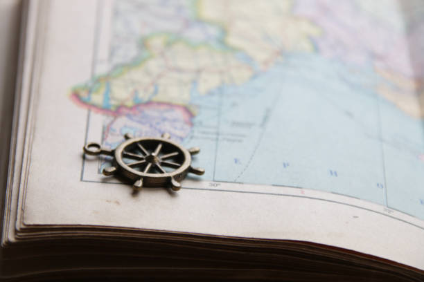 istock Ship's helm on the map. Summer vacation concept. 1458034591
