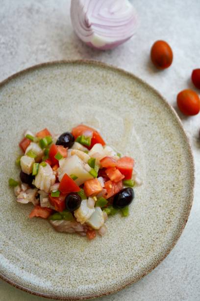istock Esqueixada, Cod fish salad with tomato and onion, olives , typical Catalan dish, Barcelona, ,Spain 1458036923
