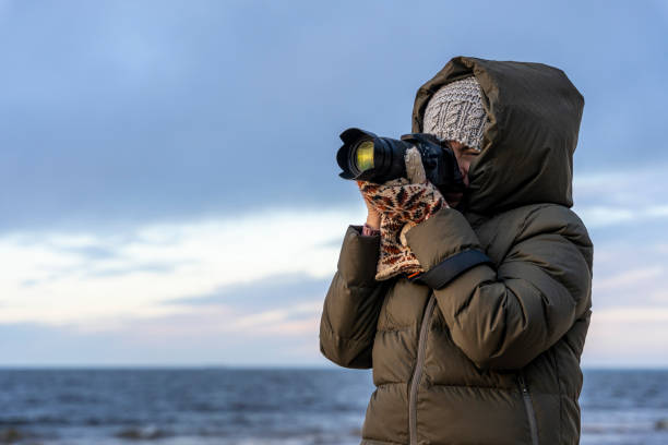 istock female photographer takes pictures with a camera 1458043507