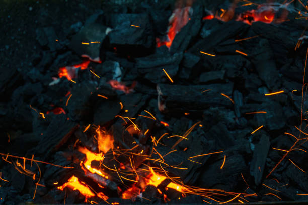 istock Coals with sparks in a huge old metal grill 1458046902