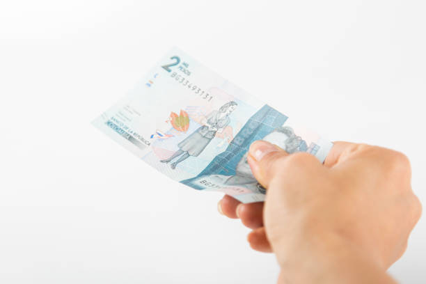 istock a person hands over a two thousand colombian pesos bill 1458048346