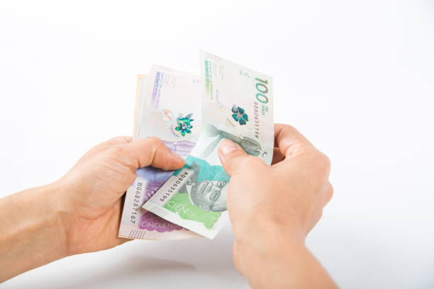 istock a person checking Colombian banknotes in his hands 1458048566