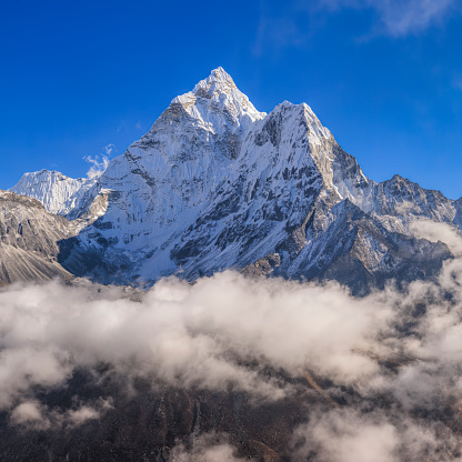196 MPix XXXXL size panorama of Mount Ama Dablam - probably the most beautiful peak in Himalayas. \n This panoramic landscape is an very high resolution multi-frame composite and is suitable for large scale printing.\n Ama Dablam is a mountain in the Himalaya range of eastern Nepal. The main peak is 6,812  metres, the lower western peak is 5,563 metres. Ama Dablam means  'Mother's neclace'; the long ridges on each side like the arms of a mother (ama) protecting  her child, and the hanging glacier thought of as the dablam, the traditional double-pendant  containing pictures of the gods, worn by Sherpa women. For several days, Ama Dablam dominates  the eastern sky for anyone trekking to Mount Everest basecamp