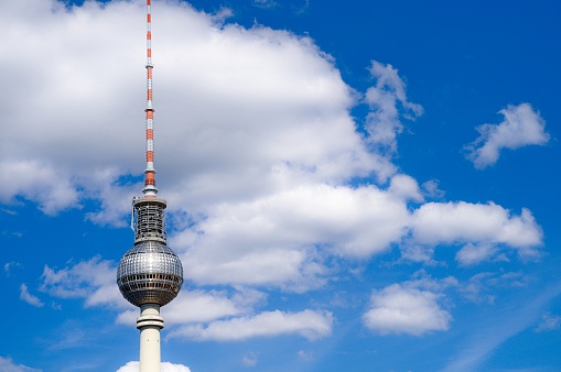 Berlin television tower top with white clouds