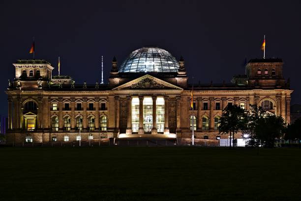 Panoramic view of famous Reichstag building, seat of the German Parliament (Deutscher Bundestag), in twilight during blue hour at dusk, Berlin, Germany