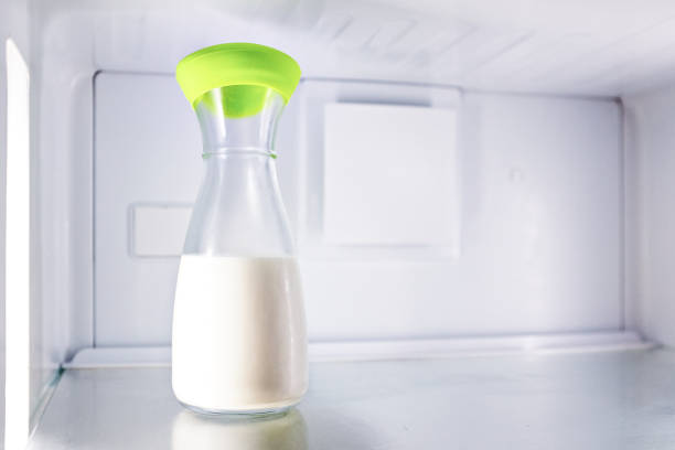 Bottle of milk stands alone in the refrigerator.