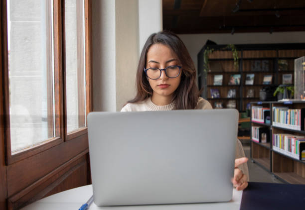 istock Young beautiful woman working with her computer 1458053460
