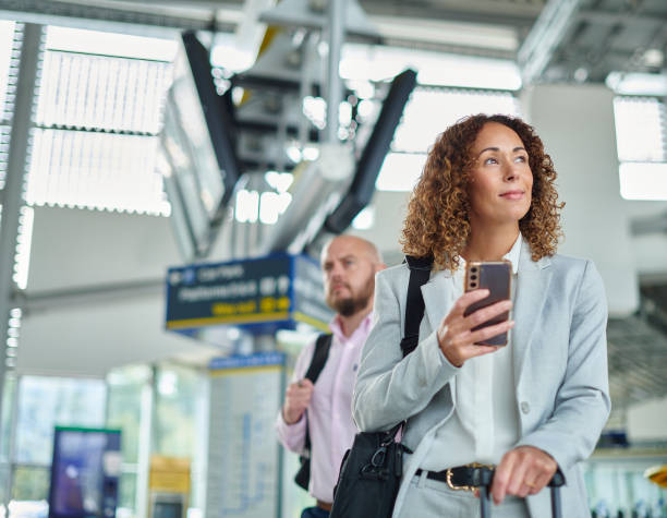 istock business traveller checking departure board 1458055576
