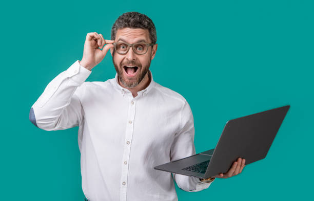 istock surprised businessman freelance in studio. businessman freelance with computer. 1458057150