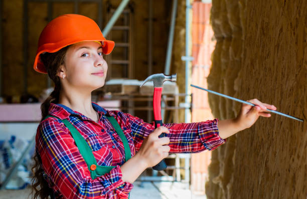 istock best repairer ever. learning to use hammer. hammering. she is good assistant. Kid engineer with carpenter work hammer. Labor day at 1 may. little girl in hard hat holds hammer 1458058841
