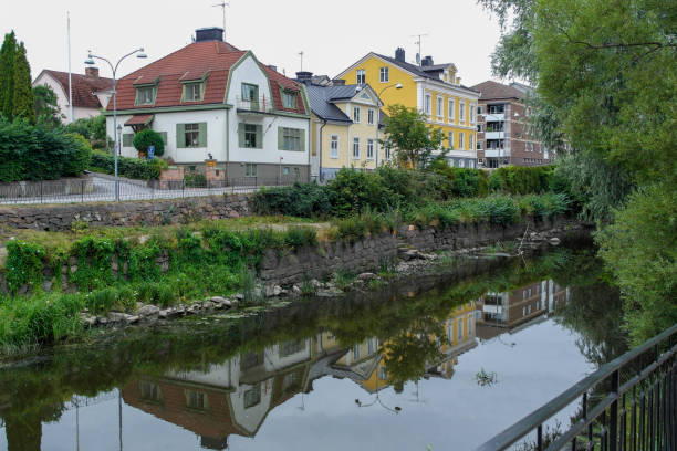 istock residential buildings by a stream during summer 1458061446