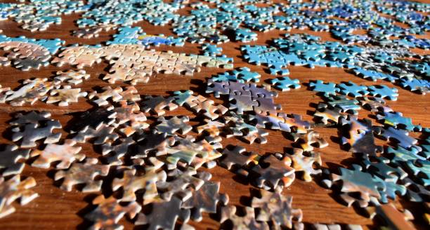 istock Jigsaw Puzzle Pieces on Wood 1458061608