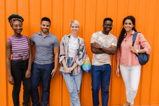 istock Young and diverse group of people standing together 1458065634
