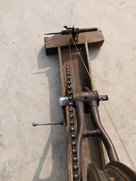 Photo of hand loom machine making thread on Charkha the spinning wheel in village at Varanasi, India. weaver prepares threads to make fabric with a handloom, spins yarn on an old fashioned spinning wheel.
