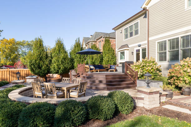 A luxury backyard brick patio. Oak Park, IL, USA - November 4, 2021: Backyard of a luxury modern farmhouse with a multiple level patio with different seating areas. back yard stock pictures, royalty-free photos & images