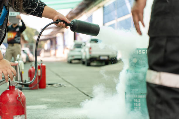 istock Hand of woman uses a CO2 fire extinguisher to extinguish a fire. 1458082799