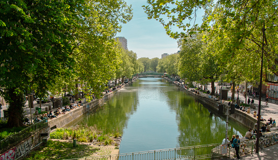 Paris, France April 20 2022 : panoramic view of the famous Canal Saint Martin, with people on its shores Paris, France.