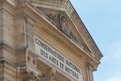 Paris, France, April 21 2023 : Facade of the Conservatoire national des arts et métiers (English: French National Conservatory of Arts and Crafts), on a sunny day.