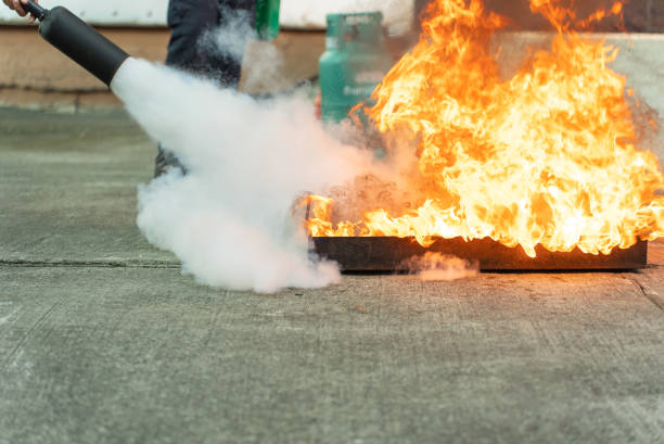 istock Hand of man uses a CO2 fire extinguisher to extinguish a fire from gasoline. 1458093632