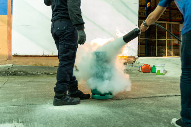 istock Hand of man uses a CO2 fire extinguisher to extinguish a fire from an LPG tank. 1458093633