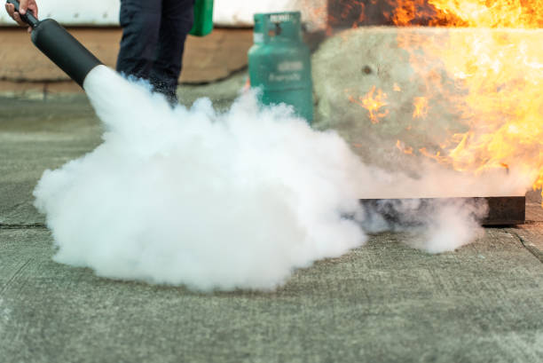 istock Hand of man uses a CO2 fire extinguisher to extinguish a fire from gasoline. 1458093634