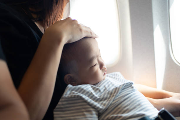 istock Baby boy sleeping in airplane 1458093724