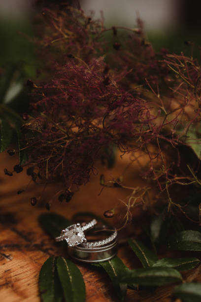 istock Close up of wedding rings with foliage 1458094051