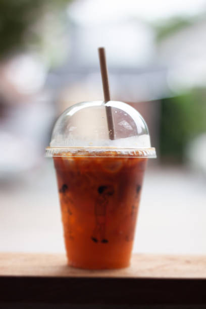 istock Black coffee with orange juice on wooden table 1458098851