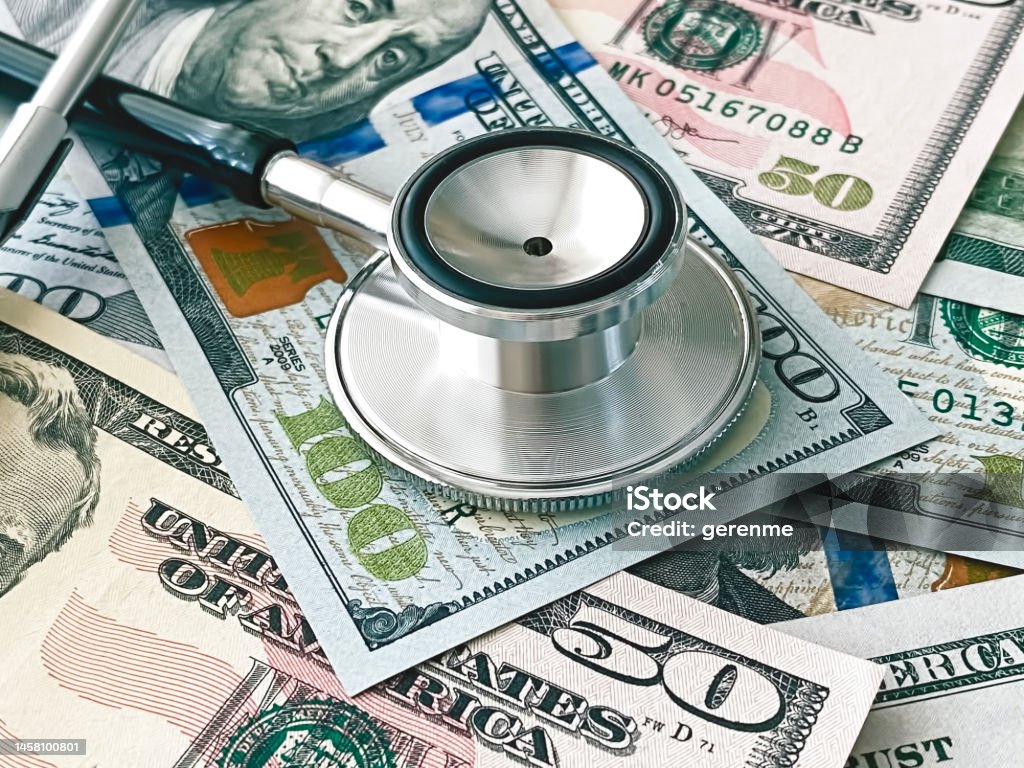 Financial surveillance Stethoscope on 100 dollar bills symbolizing financial surveillance Expense Stock Photo