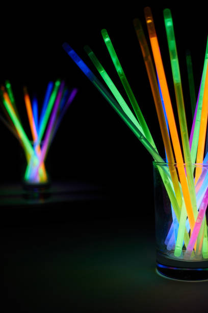 istock arrangement of multi-colored glow sticks against a black background 1458106971