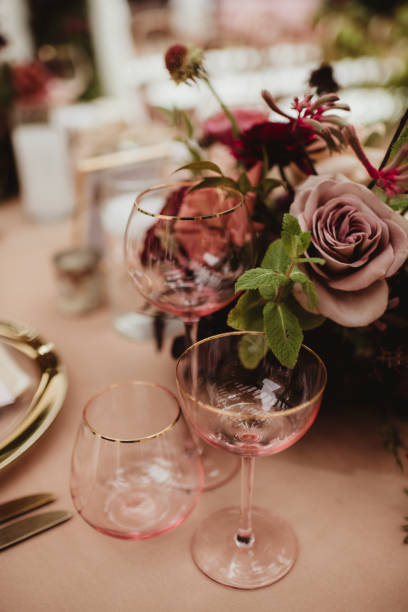 istock Pink glasses and flowers on a table at a wedding reception 1458110662