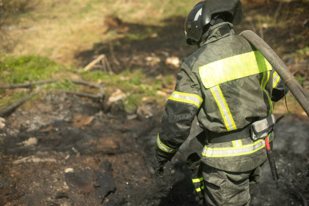 istock Firefighter puts out fire. Lifeguard pours water from hose. 1458110871