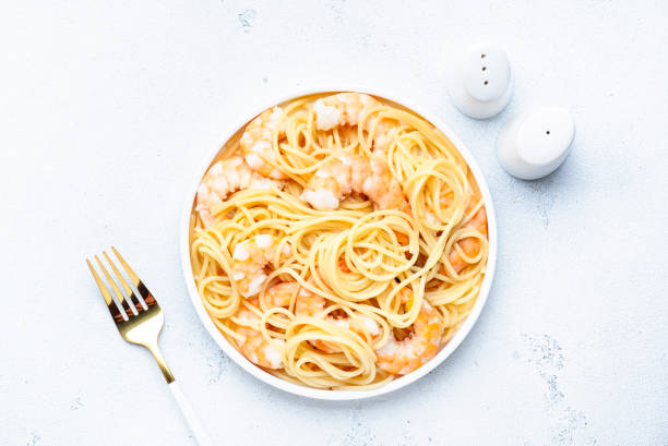 istock Spaghetti pasta with shrimp plate on white table background. Top view, copy space 1458111047