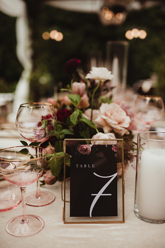 Elegant wedding dinner with table number and floral centerpiece