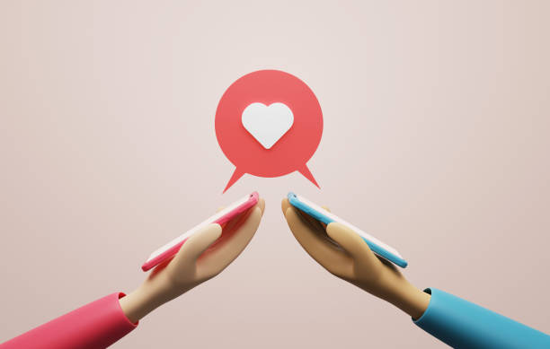 istock Mobile smartphone with speech bubble heart icon on pink background. 1458124101