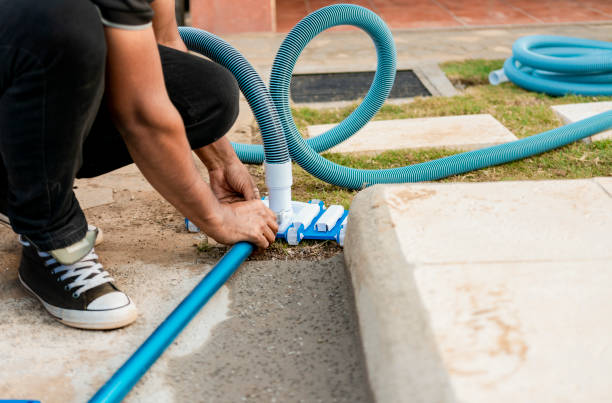istock Pool suction hose installation. Person connecting pool hose handle. Man connecting the handle on the pool vacuum. Suction equipment connection for swimming pool 1458126655