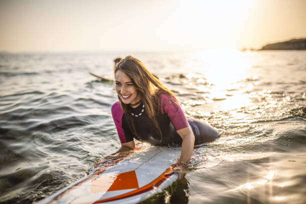 istock Surfer woman puddle on surfboard 1458127548