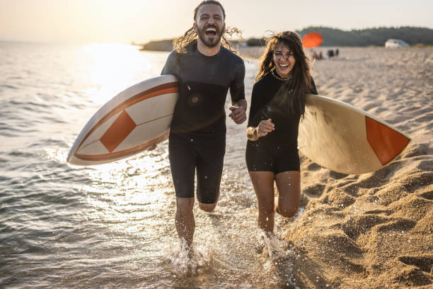 istock Surfers at the beach 1458129386