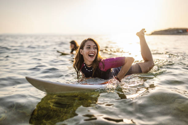 istock Surfer woman puddle on surfboard 1458131019