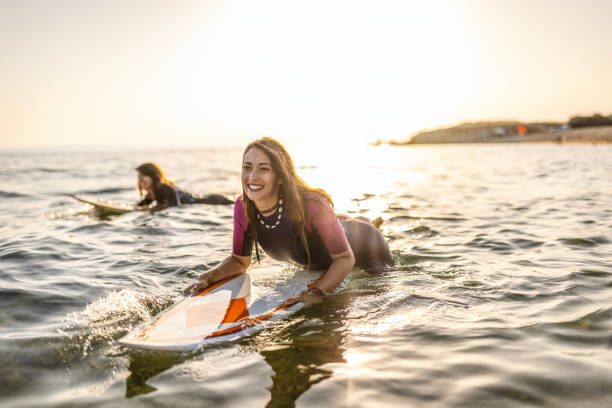 istock Surfer woman puddle on surfboard 1458132624