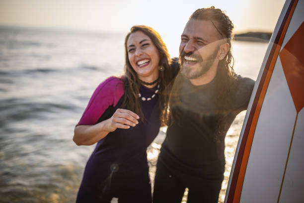 istock Surfers having fun at the beach 1458133376