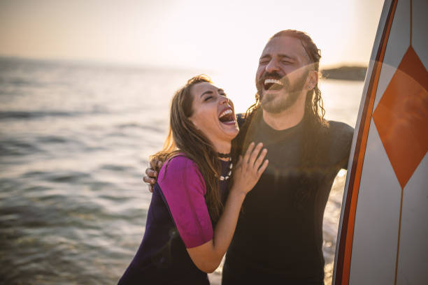 istock Surfers having fun at the beach 1458133652