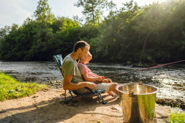 istock Father and son fishing together 1458137210