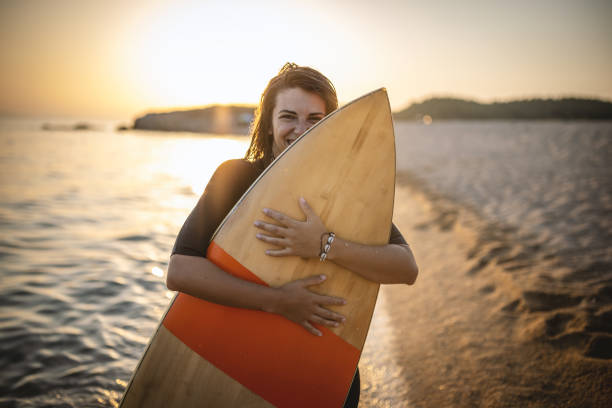 istock Surfer woman at the beach 1458137772