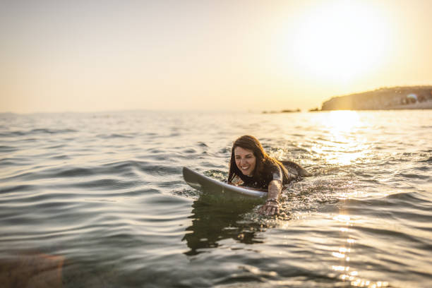 istock Surfer woman puddle on surfboard 1458138346