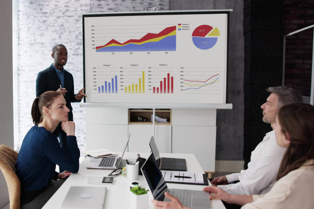 istock Businesspeople Looking At Businessman Giving Presentation 1458139875